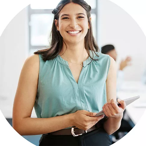 woman is smiling while holding a tablet